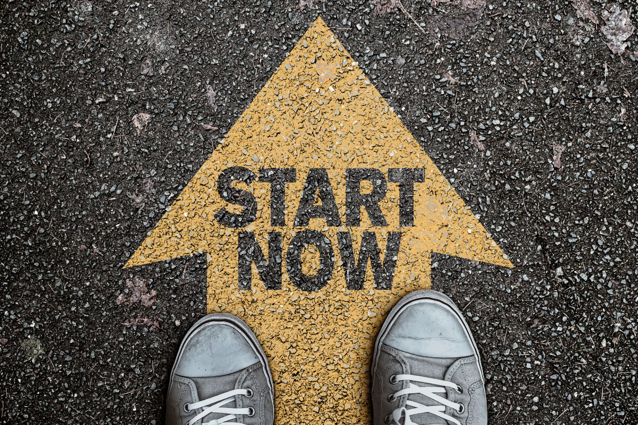 A person standing on the ground with their feet in front of an arrow that says " start now ".